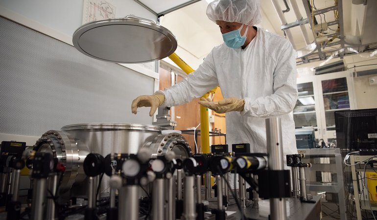 Researcher is shown testing the coating in a vacuum chamber.