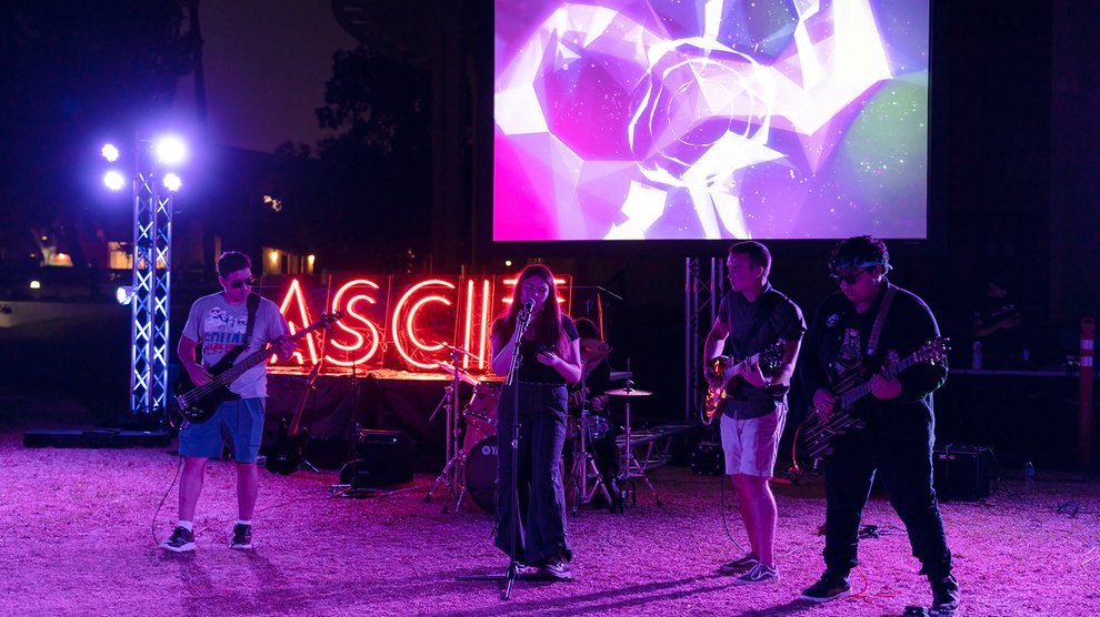 Rock band on stage at nighttime.