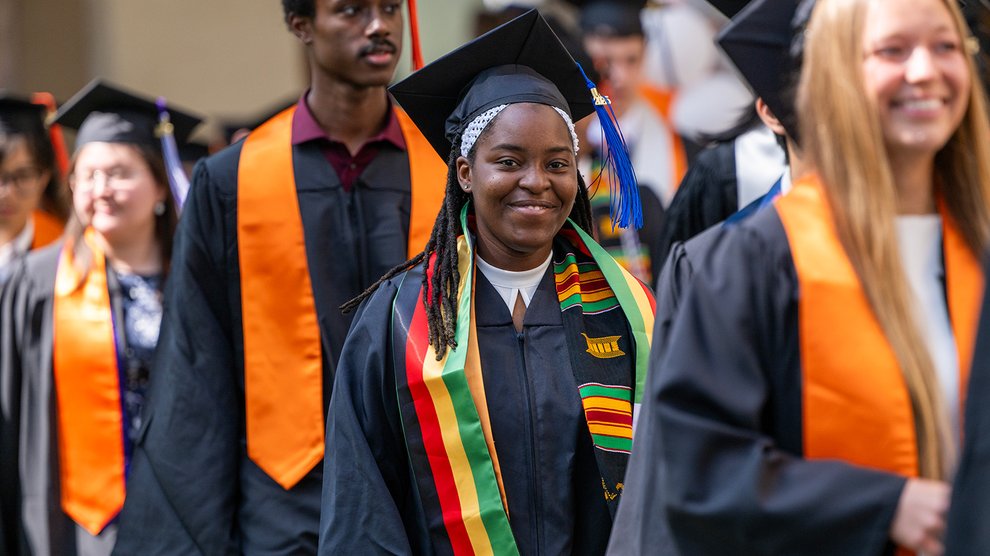 Caltech graduates enter for their commencement ceremony wearing caps and gowns.