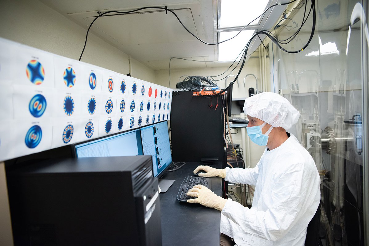 A research monitors the data from inside the chamber.