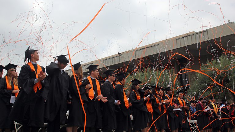 graduates with confetti