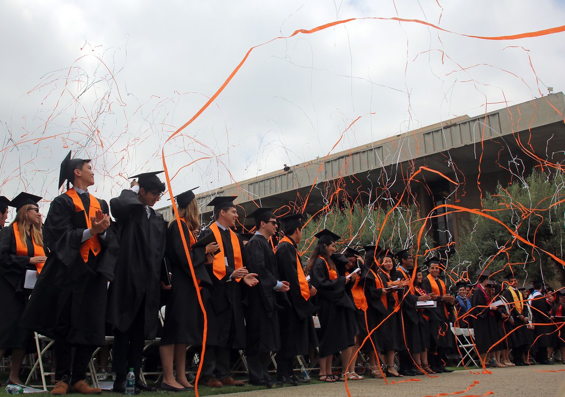 graduates with confetti