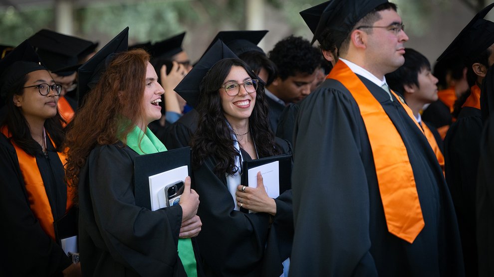 Four Caltech graduates standing at the close of their commencement ceremony
