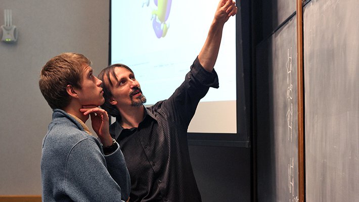 Teachers points to chalkboard