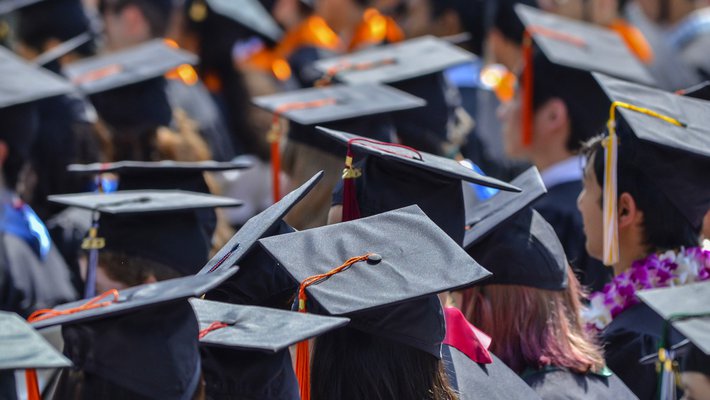 Photo of graduating students showing mortarboards.
