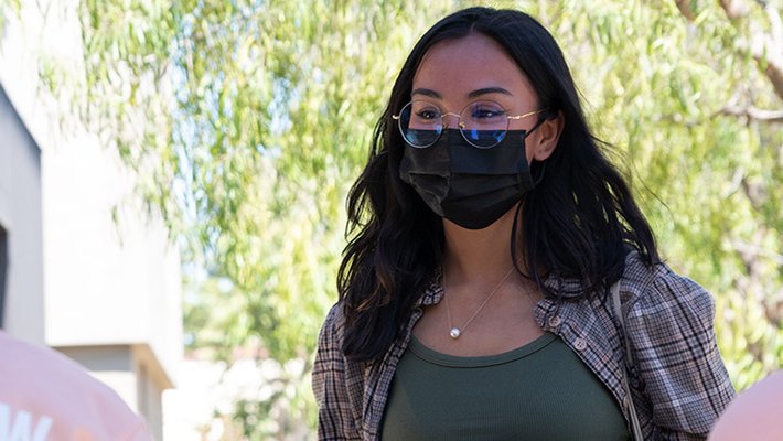 Katie Ann Huy checks in at a registration table.