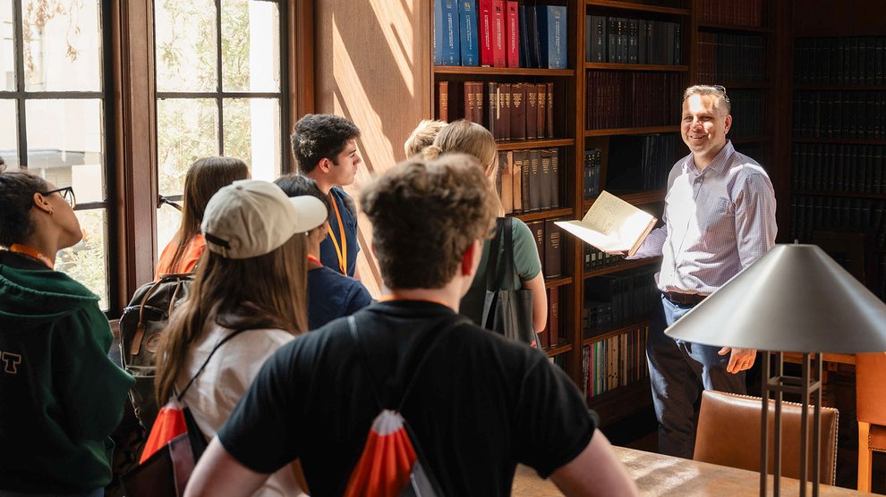 Students tour a library on campus.