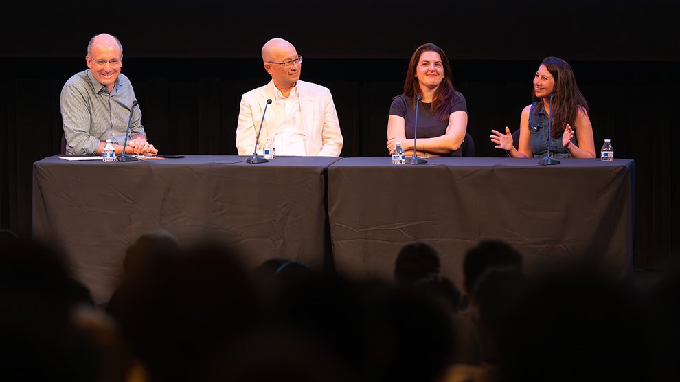 Frederick Eberhardt, Steve Chien, Georgia Gkioxari, and Katie Bouman sit at a table on stage in front of a crowd in Beckman Auditorium.