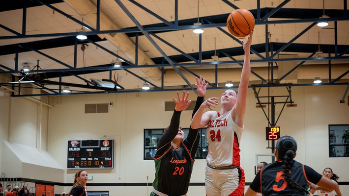 Kate Edwards leaping up to score a basket