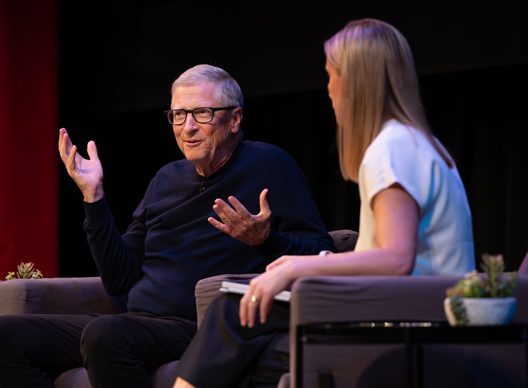 Bill Gates sits on stage in conversation with Amy Harder