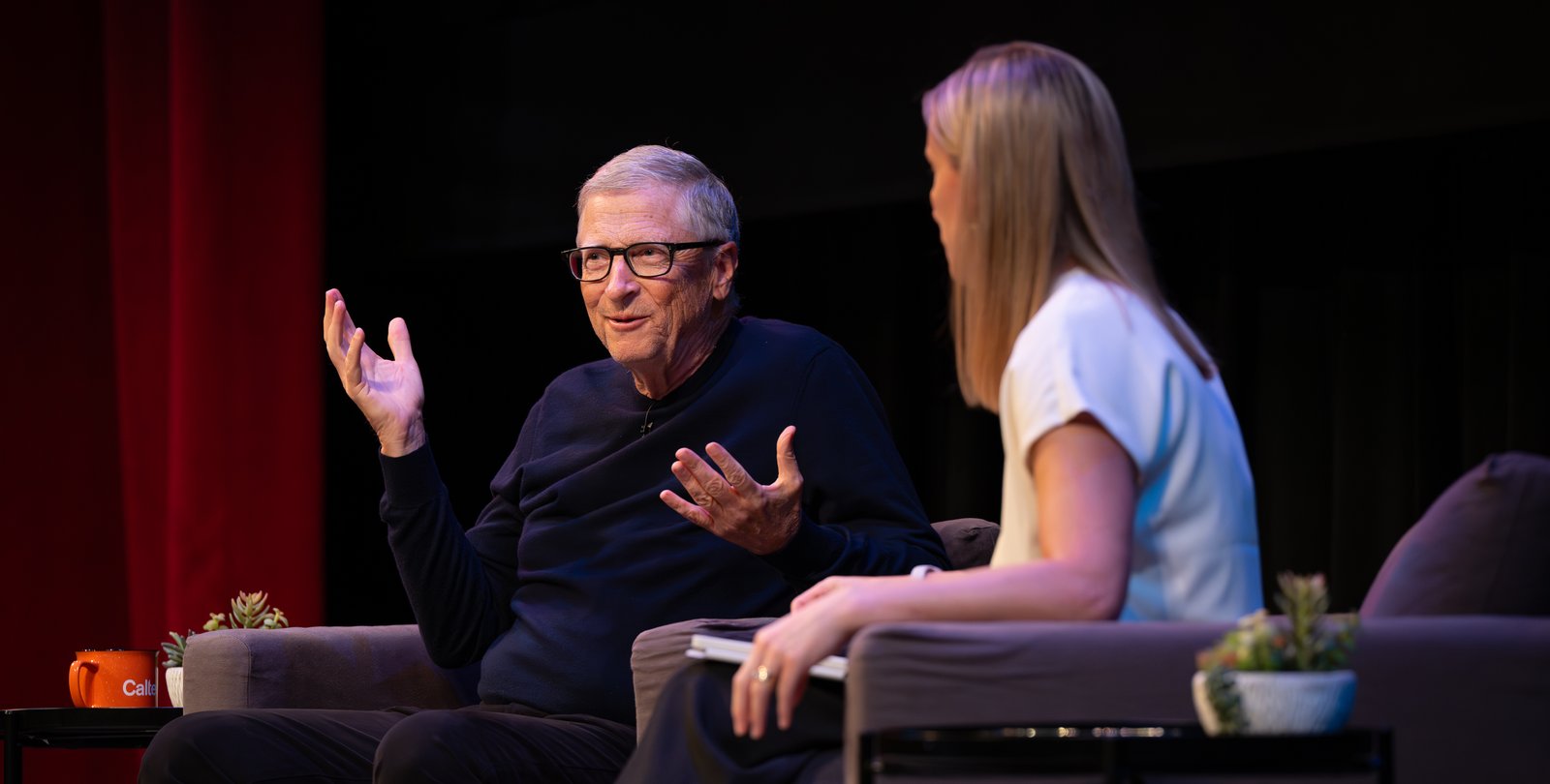 Bill Gates sits on stage in conversation with Amy Harder