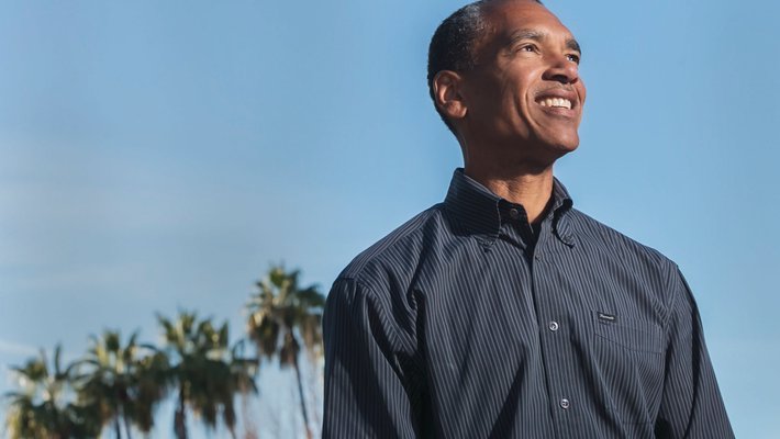 Steve Mayo in front of blue background with palm trees, the main image of the lead story in Techer