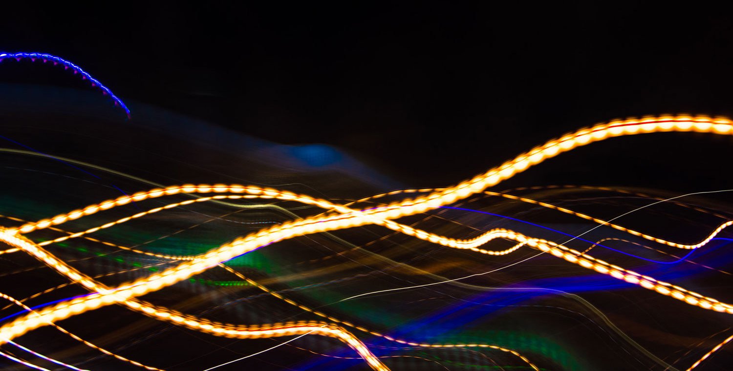 Streaks and swirls of colorful light on a black background