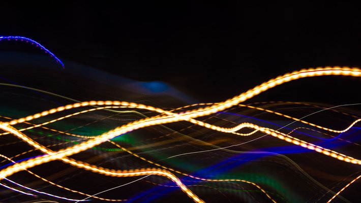 Streaks and swirls of colorful light on a black background