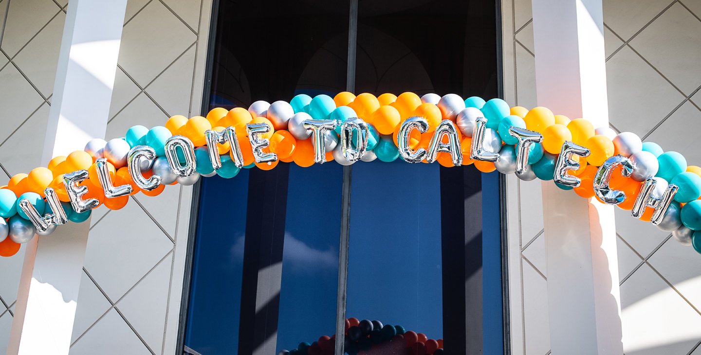A teal and orange balloon archway with Welcome to Caltech spelled out in balloons