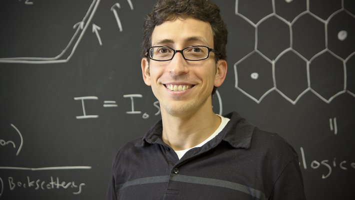 Jason Alicea in front of a chalkboard