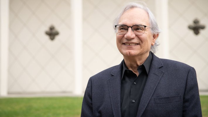 Image of Richard Andersen in a dark blazer in front of Beckman Auditorium