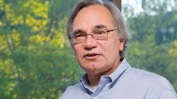Richard Andersen holding a model of a brain.