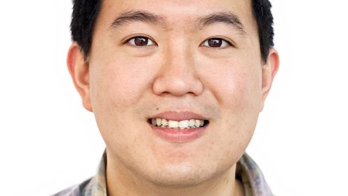 A man smiles for a photo