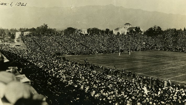 large crowd seated around an empty field