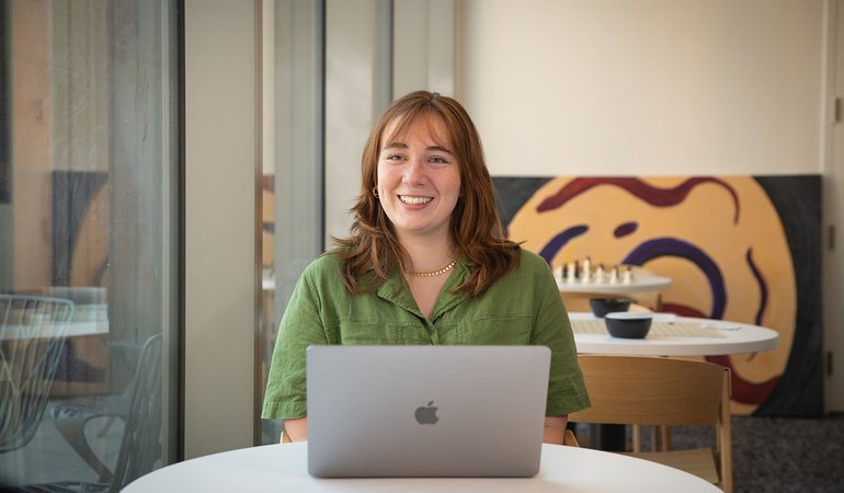 woman sits at computer