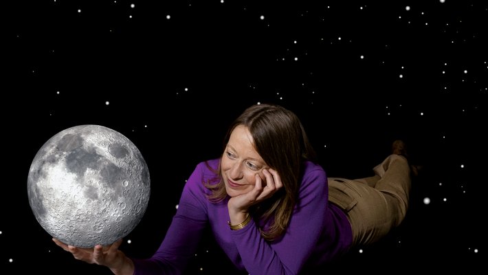 Bethany Ehlmann holding a model of the Moon in her hand