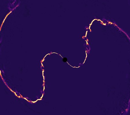 Yellow electric current lines are seen in this simulation image, whipping around a black hole.