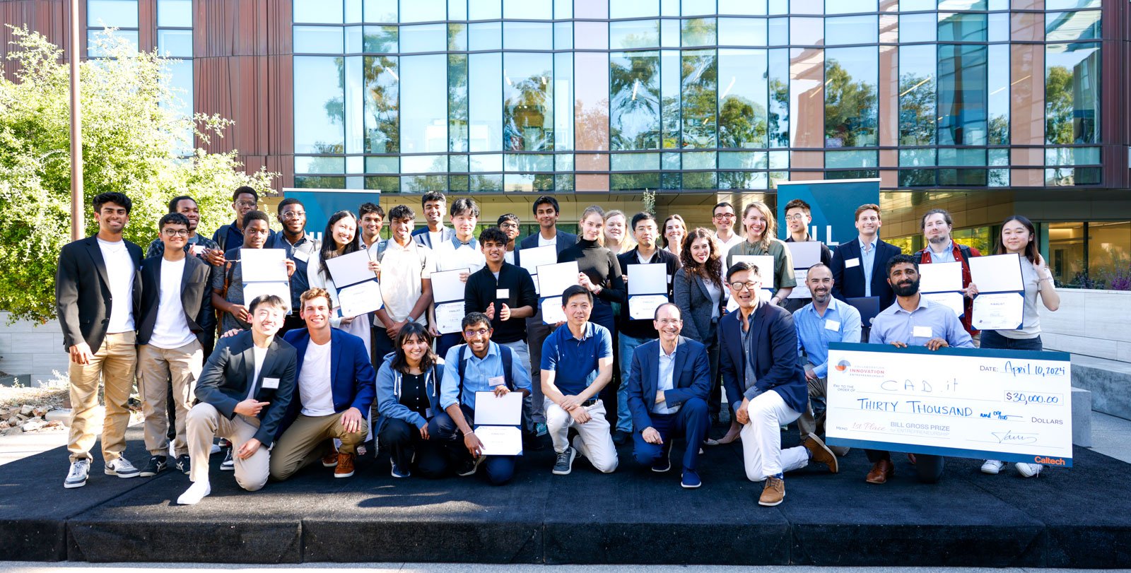 Student finalists in the Bill Gross Business Plan Competition pose with Bill Gross (first row, fourth from right) and leaders from Sunstone-ALC, Richard Jun (first row, third from right) and Zhen Wang (first row, fifth from right).