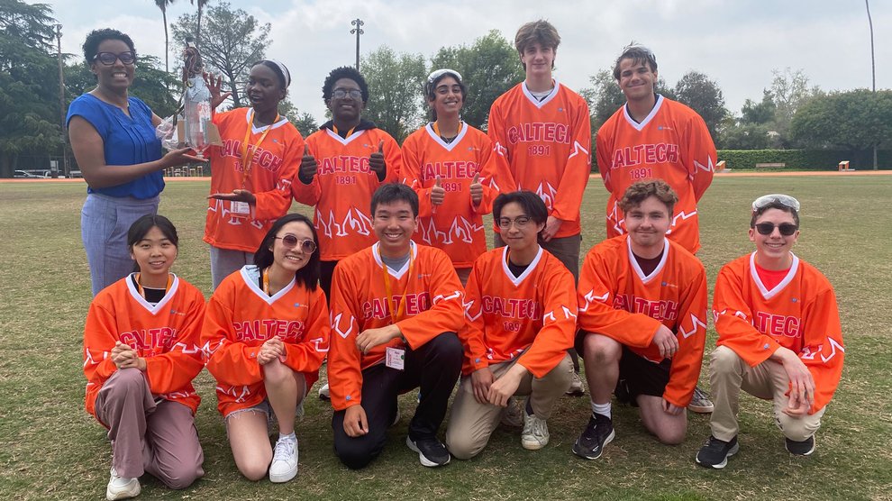 The winning team of the bottle rocket launch competition poses with Ashley Pallie and their bottle rocket