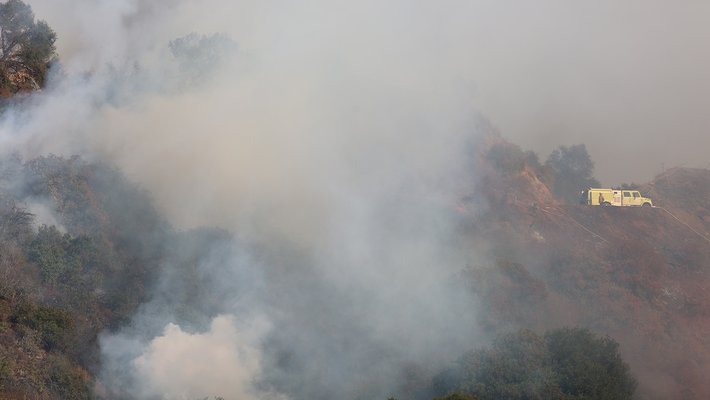 Smoke from a wildfire burning in the hills