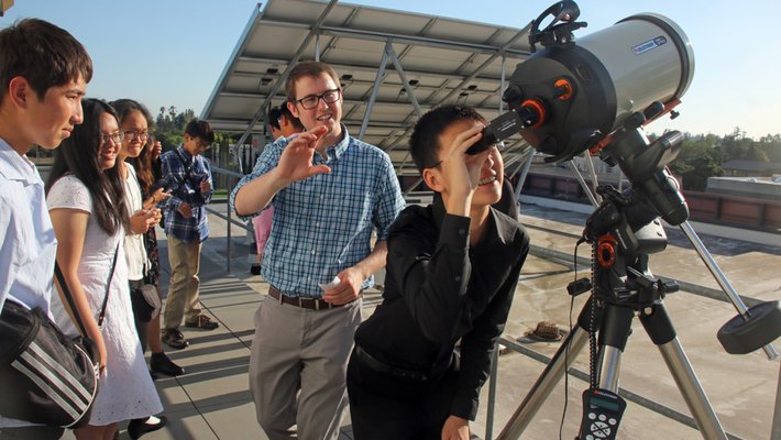 Garreth Ruane, a postdoctoral scholar in astronomy, shows visiting students from South Pasadena High School filtered views of the sun.