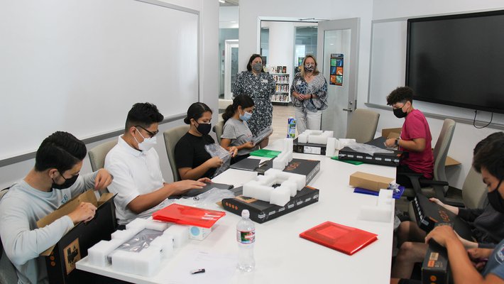 Students at Santa Ana High School in a room, with laptops in front of them.
