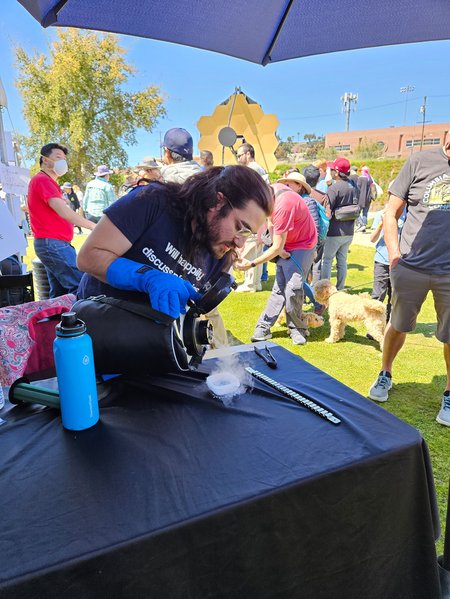 Arian Jadbabaie pours liquid nitrogen on a ceramic puck