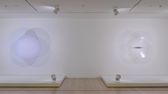 two large circular lights mounted on the wall next to one another