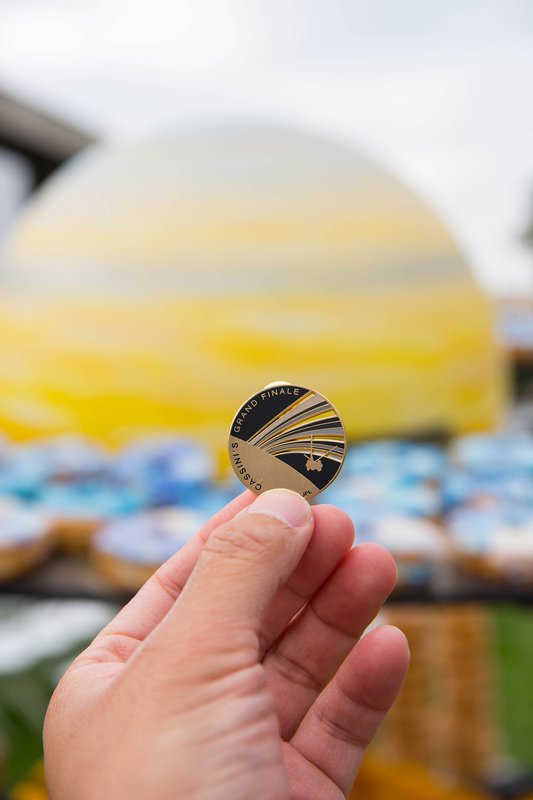 photo of commemorative medallion and donut display at Cassini Finale event