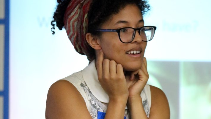 Graduate student Cecelia Sanders explains to a second grade class how genes affect the shape of body parts such as earlobes.
