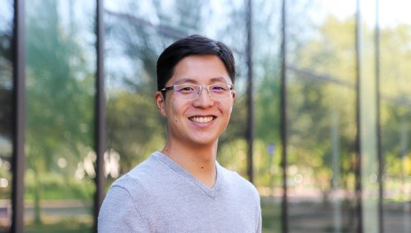 Portrait of student in front of glass building
