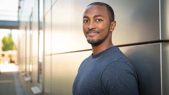 Portrait of Christopher Barnes outdoors on Caltech campus in a t-shirt