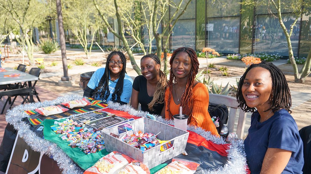 Students from the Black Student Union pose for a photo at their booth