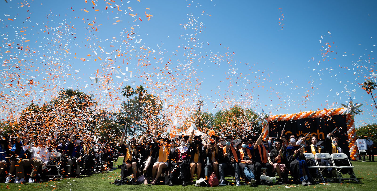 The 2021 graduates fill the air with confetti.