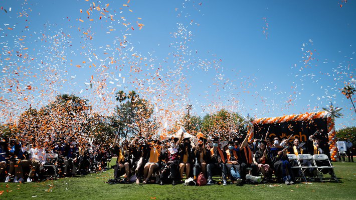 The 2021 graduates fill the air with confetti.