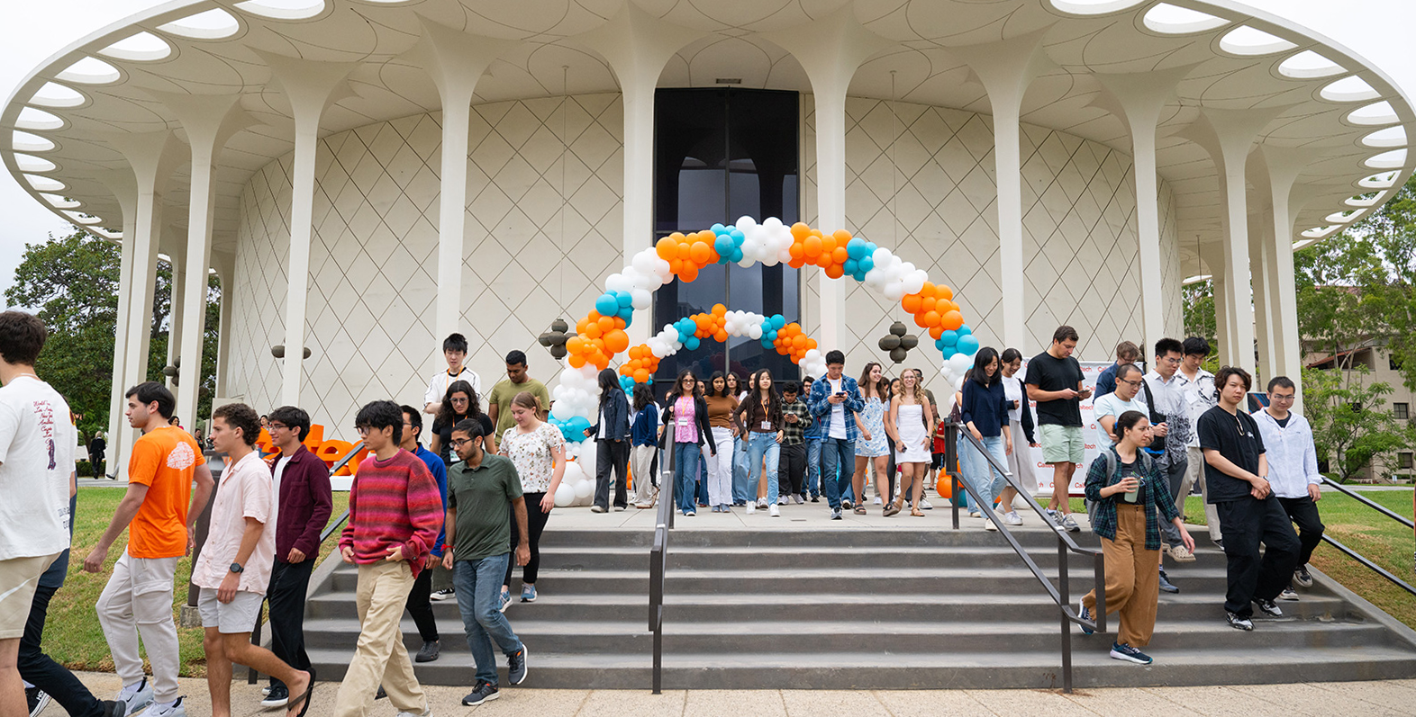 A group of new students exit Beckman Auditorium after Convocation 2025.