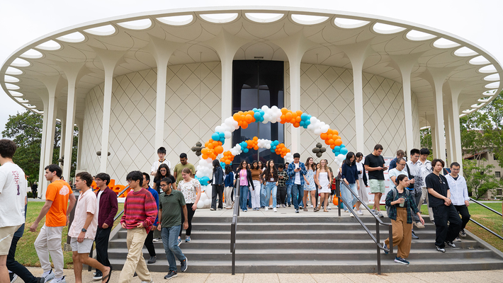 A group of new students exit Beckman Auditorium after Convocation 2025.