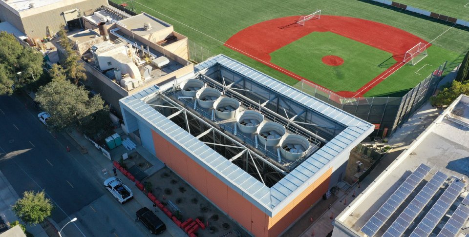 Aerial view of six cylindrical towers jutting out of a building