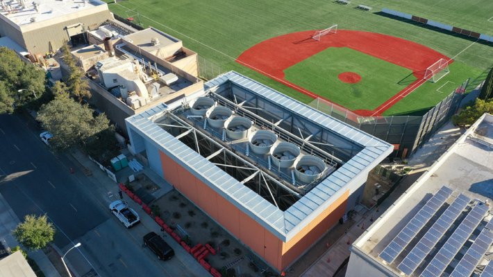 Aerial view of six cylindrical towers jutting out of a building