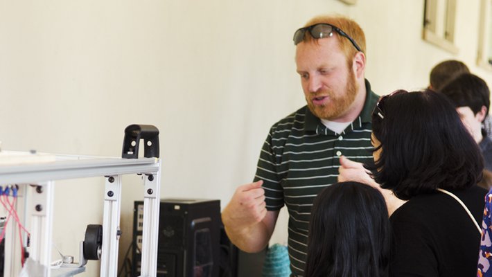 Jason Marshall, a senior postdoctoral scholar in mechanical and civil engineering, explains an experiment during Caltec