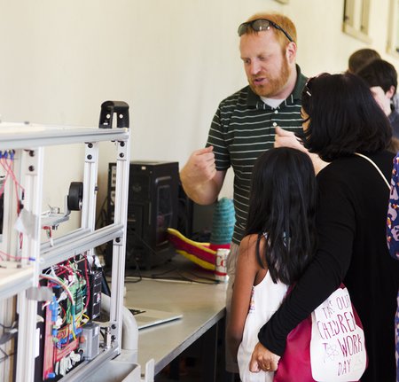Jason Marshall, a senior postdoctoral scholar in mechanical and civil engineering, explains an experiment during Caltec