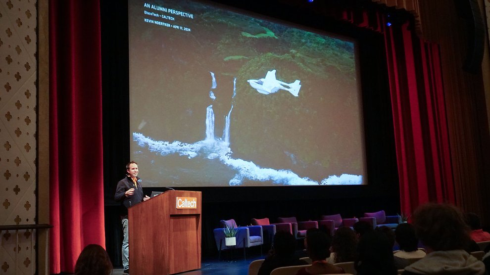 Kevin Noertker speaks onstage in Beckman Auditorium.