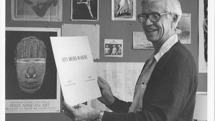 J Kent Clark laughs as he holds the album of his songs, called "Let's Advance on Science"