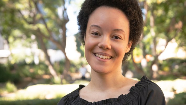 A portrait of Dana Murphy. Trees can be seen in the background.